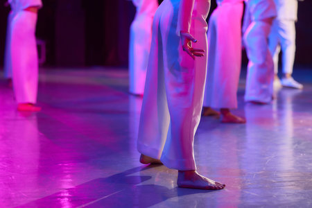 happy dancing at wedding reception. gorgeous guests and wedding couple having fun and partying in restaurant in light show.の写真素材