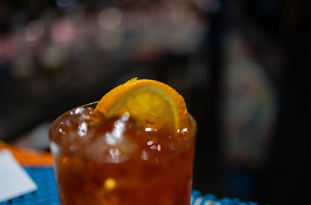 The bartender makes a cocktail at the bar, pours a glass of the shaker.