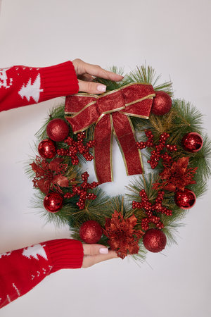 A woman is crafting a wreath for Christmas. Natural natural decoration, DIY, traditional Christmas celebration.の写真素材