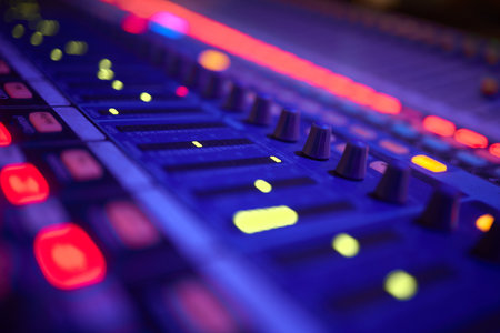View of music mixer in concert, filled with lights.