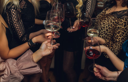 Clinking glasses with alcohol and toasting, party.の写真素材