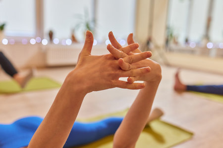 Close up of young ladys hands with rudraksha bracelets holding namaste mudra.の写真素材