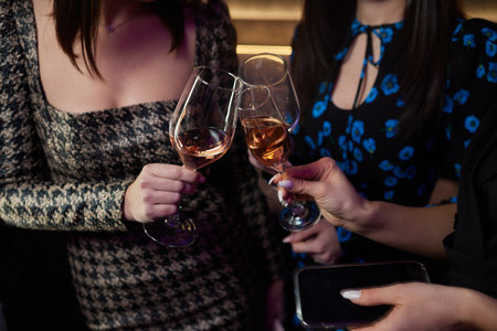 Clinking glasses with alcohol and toasting, party.