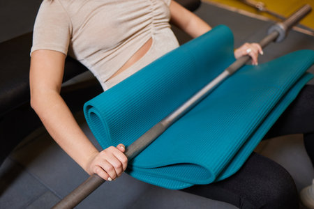 Close-up of a woman doing deadlift exercise alone at the gym.の写真素材