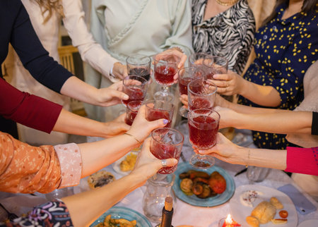 Celebration. People holding glasses of white wine making a toast.