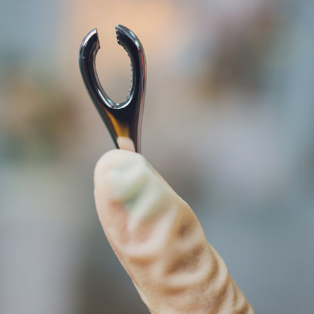 Doctors hand in gloves and holding forceps.の写真素材