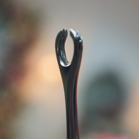 Doctors hand in gloves and holding forceps.の写真素材