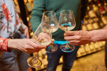 Clinking glasses with alcohol and toasting, party.の写真素材