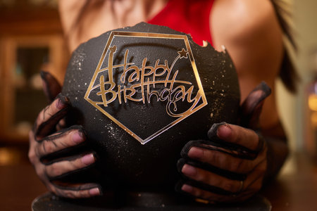 Female baker holding a delicious cake. Chef holding freshly made cake.の写真素材