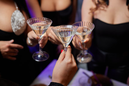 Clinking glasses with alcohol and toasting, party.の写真素材