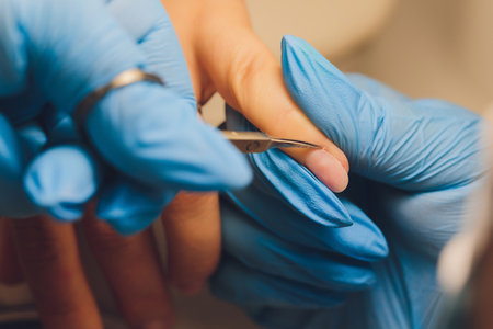 Nail care at a beauty salon. Manicurist removing edges with scissors. Let your hands look gorgeous.の写真素材