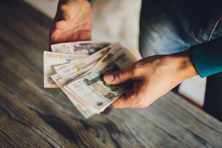 Russian rubles in the hand of a fan.male hand holding many of the Russian banknotes.The transfer of money.The isolated five-thousandth of Russian rubles denominations in a hand.の写真素材