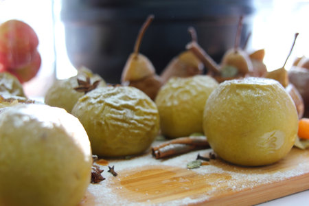 Close-up of a caramelized pear in wine with chocolate sponge cake, homemade yogurt and walnuts in warm colors.の写真素材