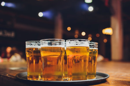 Waiter serving glasses of cold beer on the tray.の写真素材