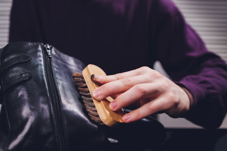 a man is painting shoes, blue shoe polish,Painted blaue leather shoes, a pair of painted mens shoes.の写真素材