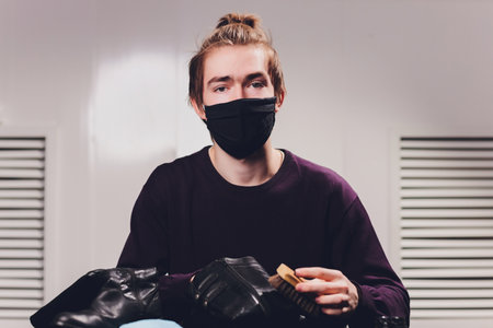 a man is painting shoes, blue shoe polish,Painted blaue leather shoes, a pair of painted mens shoes.の写真素材