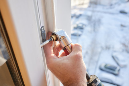 The worker installing and checking window in the house.の写真素材