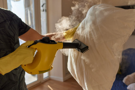 man steaming pillow at home, closeup view.の写真素材