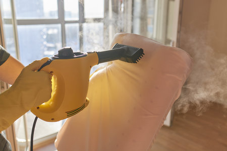 man steaming pillow at home, closeup view.の写真素材