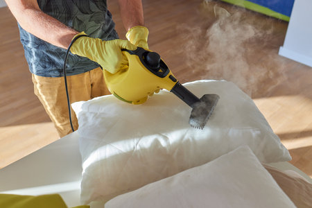 man steaming pillow at home, closeup view.の写真素材