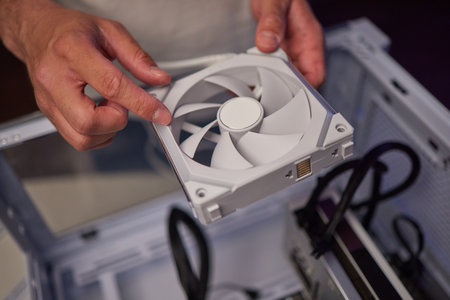 Computer technician installs cooling system of computer.の写真素材