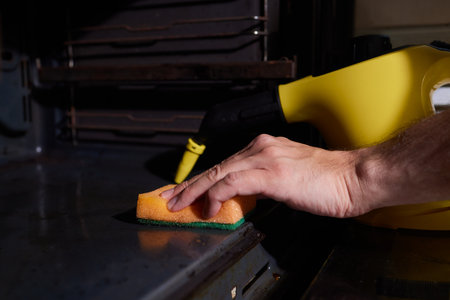 steam cleaning oven house cleaning hand close-up.の写真素材