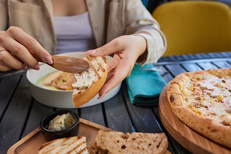 Healthy breakfast. happy young woman preparing tasty snacks at the kitchen table in the morning...