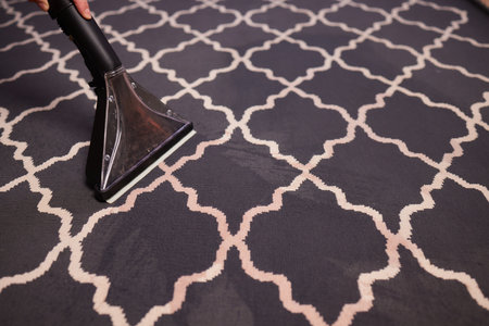 Close-up Of A Person Cleaning Carpet With Vacuum Cleaner.の写真素材