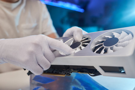 Changing the thermal paste on the graphics processor. Disassembled graphics card on the table. Old...