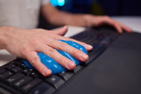 Blue soft gel cleaning dust on keyboard. Concept cleaning your computers keyboard. Office cleaning.の写真素材