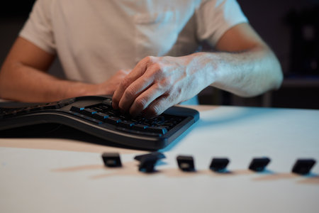 Old dirty computer keyboard with removed keys. The tools for repair and cleaning on the table in the workshop workspace.の写真素材