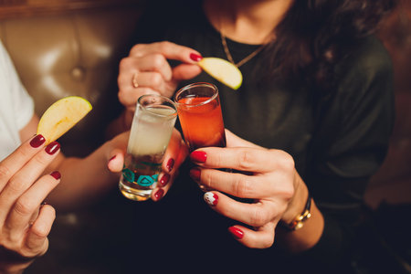 people at the festival hold alcoholic cocktails in their hands.の写真素材