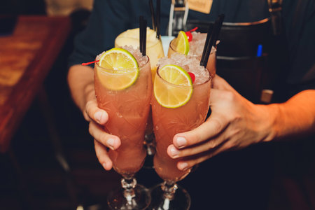 people at the festival hold alcoholic cocktails in their hands.の写真素材