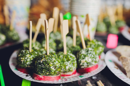 Useful Food: Cheese balls with crackers, herbs and pumpkin seeds close-up on a plate. horizontal.の写真素材