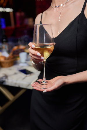 Clinking glasses with alcohol and toasting, party.の写真素材