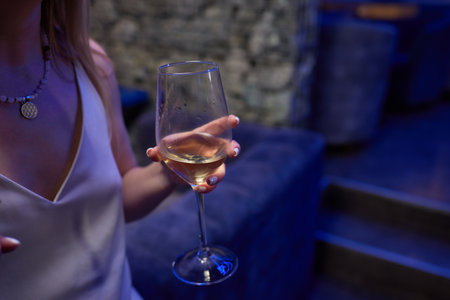 Clinking glasses with alcohol and toasting, party.