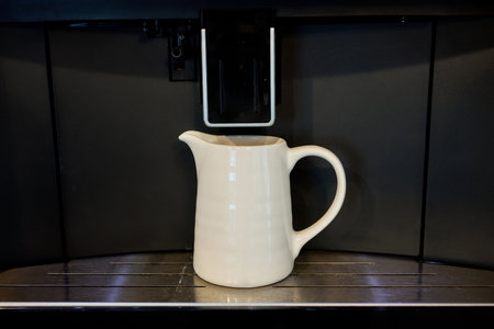 black coffee machine and white cup of coffee in dark space.の写真素材