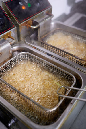 Dirty cooking area with french fries deep fryer.の写真素材