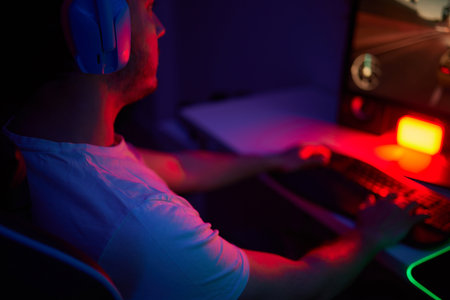 Player looking at his computer screen, contemplating his next move in an online video game.の写真素材