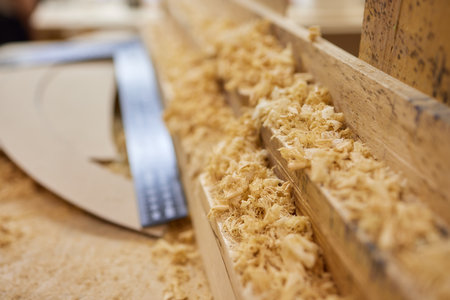 close up of a carpenter screwed a hinge on a wooden plank.の写真素材