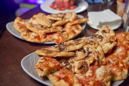 Stack of Pizza slices at the hotel buffet.