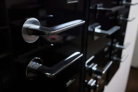 Door closers in a specialized store. Many different door and gate closers. Concept - sale of entry fittings. Door hardware store. Accessories for swing gates. Closers for building gates.の写真素材