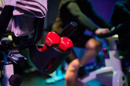 Group fitness riding a exercise bikes. Three athletes girlfriend pedaling on a stationary bike at...