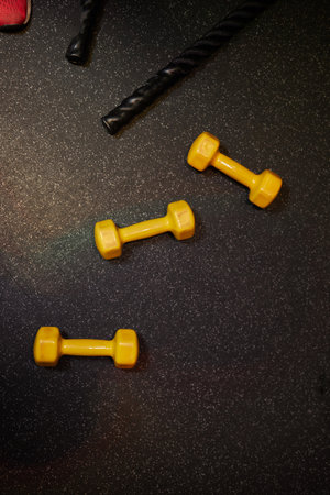 Stand with dumbbells. Sports and fitness room. Weight Training Equipment. Black dumbbell set, many...