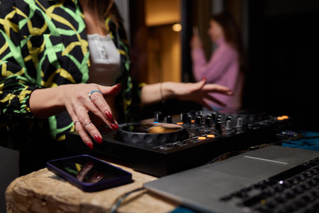 DJ turntable console mixer controlling with two hand in concert nightclub stage.の写真素材