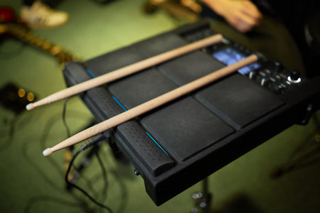 Drum sticks are on the electronic drum. Theme music.
