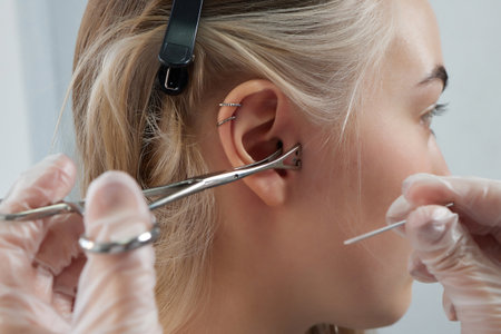 Professional holding the jewel of piercing day just before screw the ball. Tragus type.の写真素材