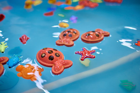 Multicolored plastic toy fish in pool for childrens fishing, concept game.の写真素材