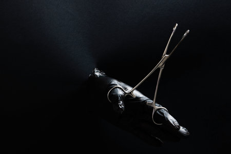 hand-held stainless steel surgical scissors with gloves.の写真素材