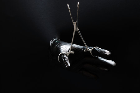 hand-held stainless steel surgical scissors with gloves.の写真素材